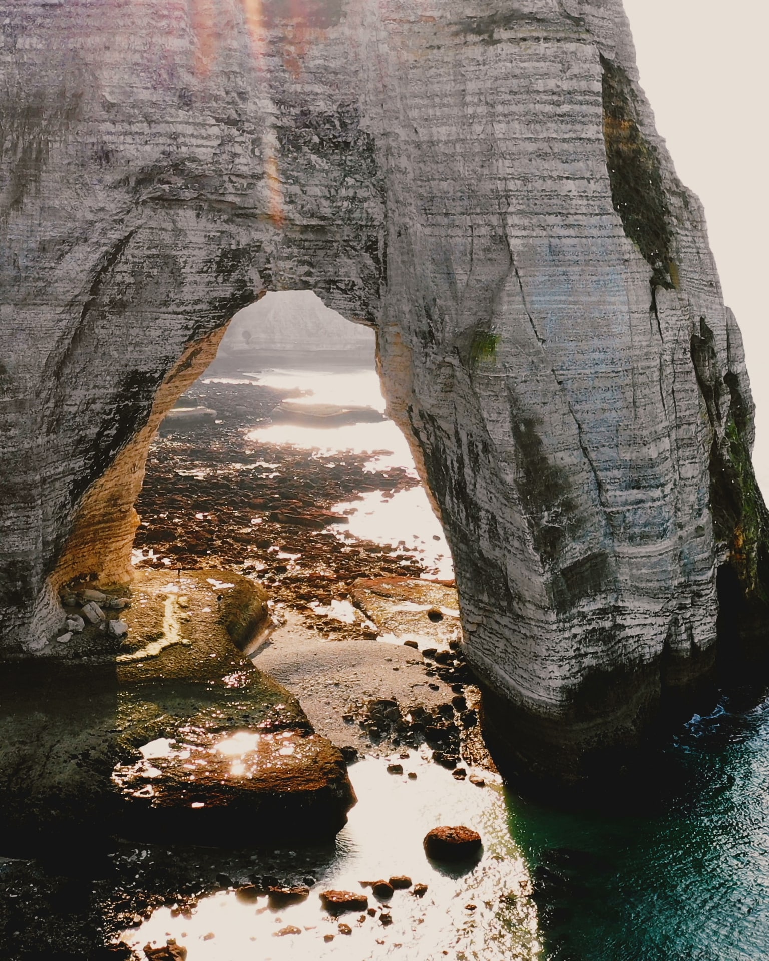 Evening light through a chalk sea arch at Étretat, Normandy