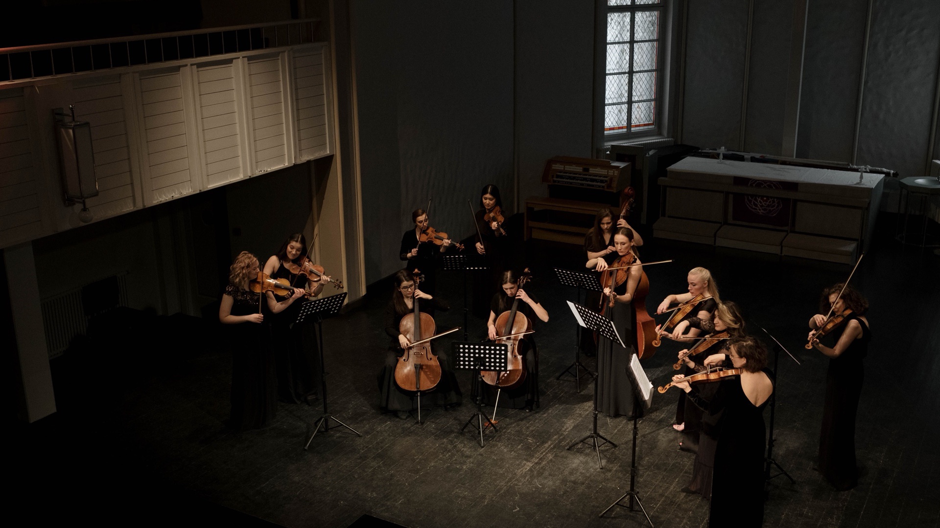 A string ensemble performing in an intimate hall